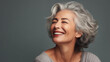 © goami - middle age woman with grey hair smile in studio, 50s 60s senior  female laughing, skincare and beauty concept