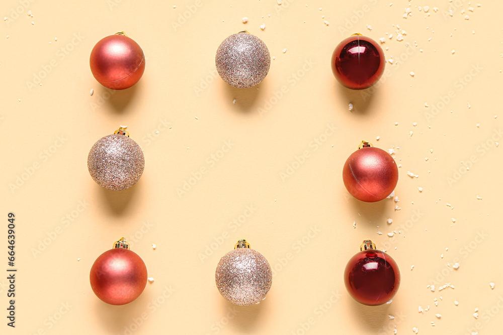Frame made of Christmas balls on beige background