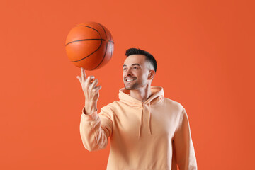 Poster - Happy young man with ball on orange background