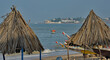 West Africa. Senegal. Conical umbrellas made of reeds and long palm leaves on the sandy beach of the resort town of Ngaparou on the Atlantic Ocean.