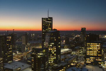 Beautiful aerial evening view of illuminated business district in Vilnius. Winter sunset in capital of Lithuania.