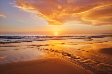 Atlantic ocean sunset with surging waves at Fonte da Telha beach, Costa da Caparica, Portugal