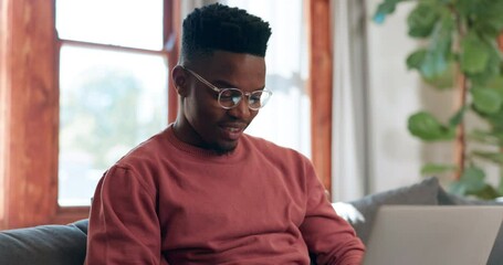 Poster - Man, glasses and thinking for typing in living room for message by email on sofa. Black person, happy and excited with technology for internet, web, or app for communication, remote or work from home