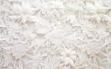 Fototapeta  - Closeup of textured fabric pattern with elegant vintage lace and floral hand embroidery on a white background. Decorative wedding design.