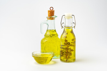 Bottles of two cooking oils on white background