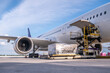 © Supakit - Air cargo logistic containers are loading to an airplane. Air transport shipment prepare for loading to modern freighter jet aircraft at the airport.