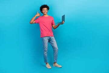 Sticker - Full body photo of attractive young man show thumb up hold laptop dressed stylish pink clothes isolated on blue color background