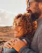 © simona - Happy couple hugging and enjoying travel destination. together with smile and serene expression. One man embrace woman from behind. Concept of traveler vacation lifestyle. Sunny portrait of people