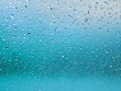 abstract wet raindrops dripping down from the window glass after a rainy day. wallpaper texture background 