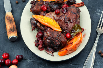 Wall Mural - Baked chicken legs with berries in wine sauce.