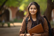 © PRASANNAPIX - Indian female student with books and bag