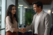 © Neha - Two Indian business man and woman shaking hands