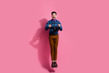 Canvas Print - Full length photo of carefree handsome guy using car driving simulation app using steering wheel in air isolated on pink color background