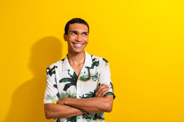 Wall Mural - Photo of good mood pleasant man dressed palm print shirt arms folded look at promo empty space isolated on yellow color background