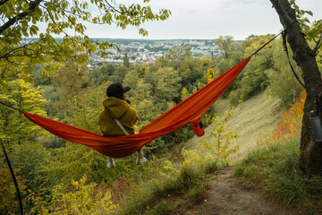 Canvas Print - woman view from behind sitting on the hammock enjoying view