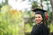 © EduLife Photos - Portrait middle-age female university graduate wears academic gown celebrates diploma degree