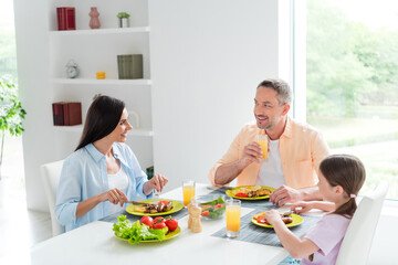 Poster - Portrait of positive couple small daughter spend free time together eat homemade food drink fresh juice flat inside