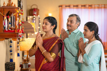Indian Middle Class Family Praying To God During Diwali Festival Celebration In Front Mandapam - Concept Of Traditional Custom, Special Ceremony And Sacred Customs