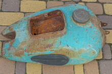 Open Rusty Iron Glove Compartment Lid For Tools In An Old Green  Rusty Retro Empty Gasoline Tank Of  A Classic Retro Heavy Broken Motorcycle Lies On A Yellow Concrete Surface On The Street