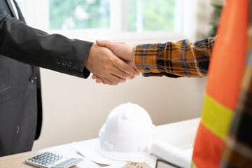 Wall Mural - Construction team hands shaking greeting start up plan new project contract in office center at construction site, industry ,architecture, partner, teamwork, agreement, property, contacts.