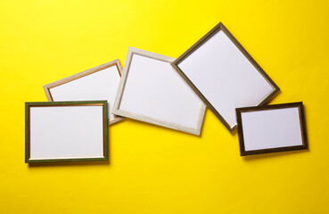 Blank wall frames on yellow background