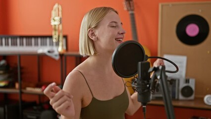 Poster - Young blonde woman musician singing song dancing at music studio