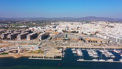 Canvas Print - Aerial drone footage of the Portuguese southern town of Olhao. View of the city and harbor, sailboats and hotels