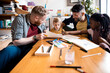 © Marko Geber - Male gay couple drawing with their adopted children at home