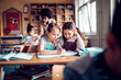 © Marko Geber - Young female pupils working together in a elementary school class
