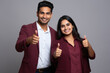 © vefimov - Picture of man and woman both giving thumbs up gesture. This image can be used to convey approval, success, or agreement in various contexts.