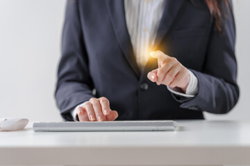 Business asian female professionals worker using computer keyboard diving into digital tasks, showcasing dedication and finesse, all from their workstations, cloud computing.