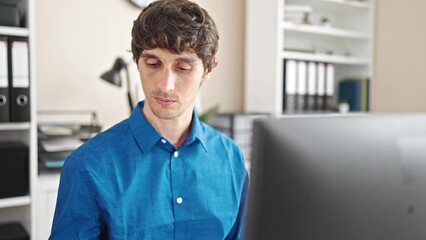 Sticker - Young hispanic man business worker using computer and smartphone at the office