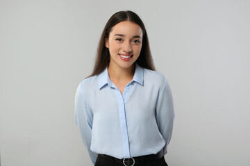 Wall Mural - Portrait of beautiful young woman on light grey background