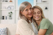 © New Africa - Happy mature mother and her daughter hugging at home