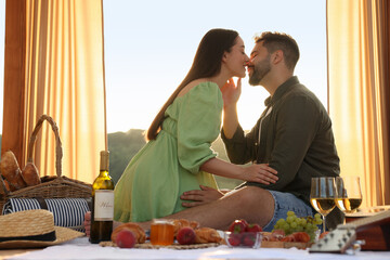 Wall Mural - Romantic date. Beautiful couple kissing during picnic on sunny day