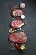© New Africa - Pieces of raw beef meat, products and spices on black textured table, flat lay