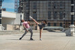 © qunica.com - Full length photo of a male sports person kicked in a face by his flexible female friend, kickboxer
