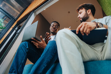 Diverse professionals collaborating in a modern co-working space. They are problem-solving and gathering data for a new project. This determined team is focused on success in their vibrant workplace.