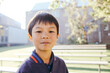 © Austockphoto - Portrait of primary school boy in the playground at school