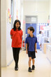 © Austockphoto - Happy primary school students together in hallway at school