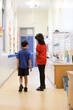 © Austockphoto - Two school students walking away in the corridor