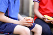 © Austockphoto - primary school student holding healthy apple for fruit break
