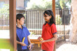 © Austockphoto - two primary school students holding healthy food for fruit break