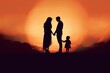 © Khalada - Shadow of Happy family together, parents with their little baby at sunset. A Silhouette of Love and Unity.