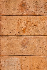  Four orange bricks close up of horizontal stone wall with textured surface