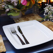 Blank plate with fork and knife on table
