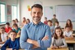 © Eman Suardi - male teacher in a class at elementary school looking at camera with learning students on background