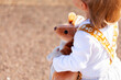 © Austockphoto - Aussie kangaroo toy held by toddler child outside