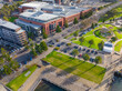 © Austockphoto - Aerial view of a green city waterfront reserve alongside an esplanade and high rise buildings