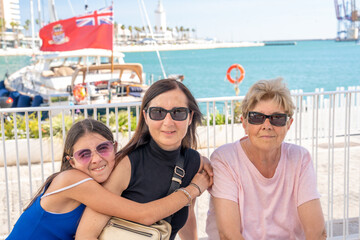 Sticker - A happy family of three people of different generations enjoying outdoor time near the port